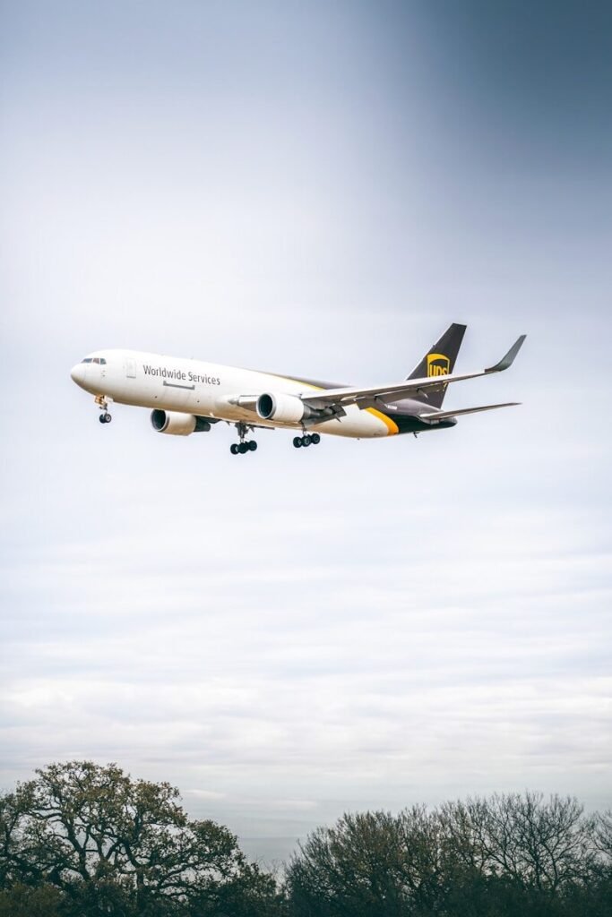Ups cargo plane flying in cloudy sky